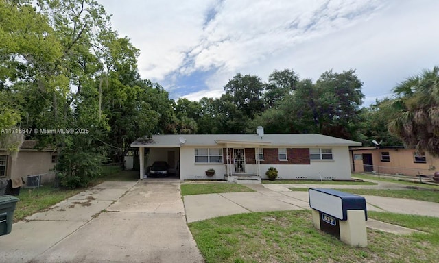 ranch-style house with a front lawn and a carport