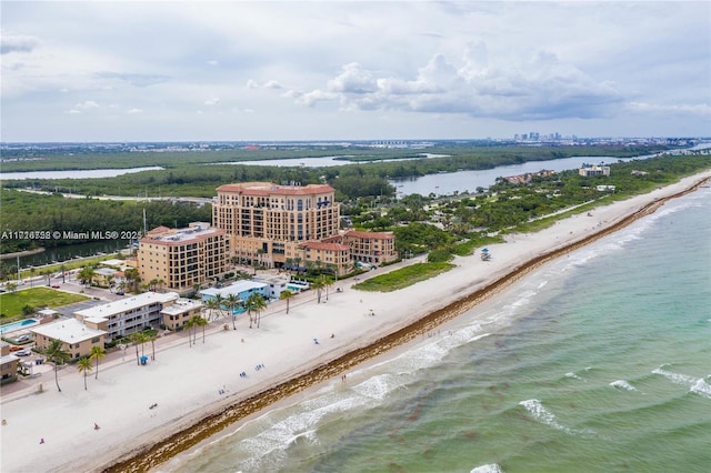 birds eye view of property featuring a water view and a beach view