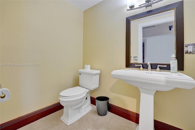 bathroom featuring toilet and sink