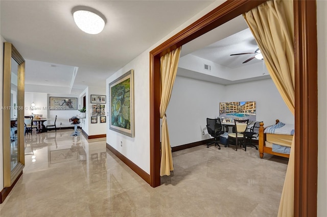 hallway with a raised ceiling