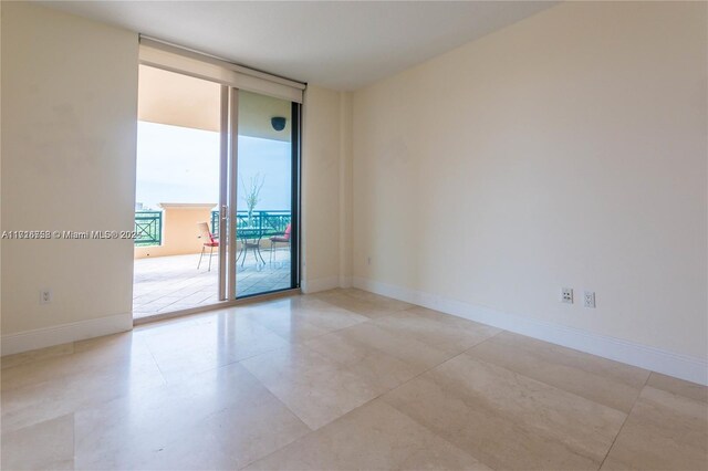 empty room featuring a wall of windows