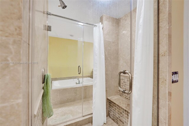 bathroom with tile patterned flooring and separate shower and tub