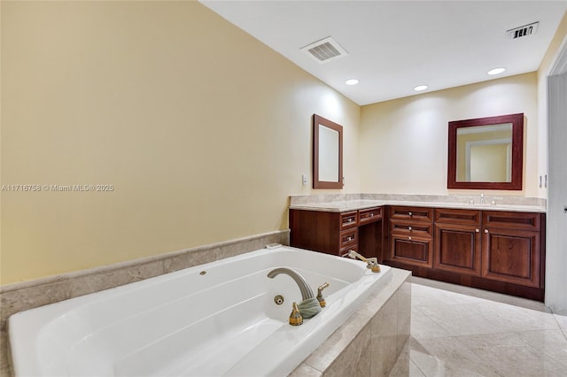 bathroom featuring vanity and a relaxing tiled tub