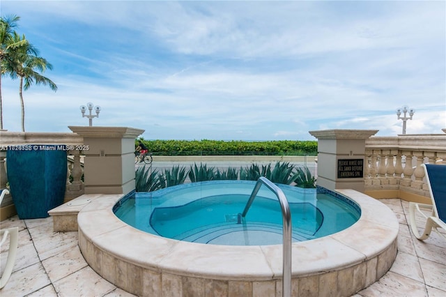 view of swimming pool featuring an in ground hot tub