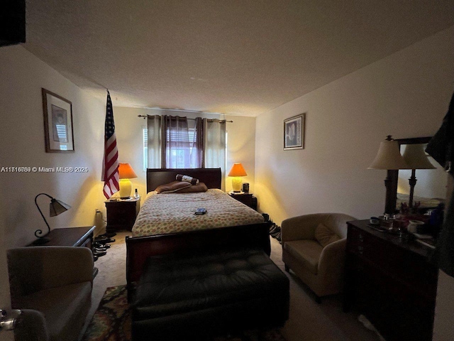 bedroom with carpet and a textured ceiling