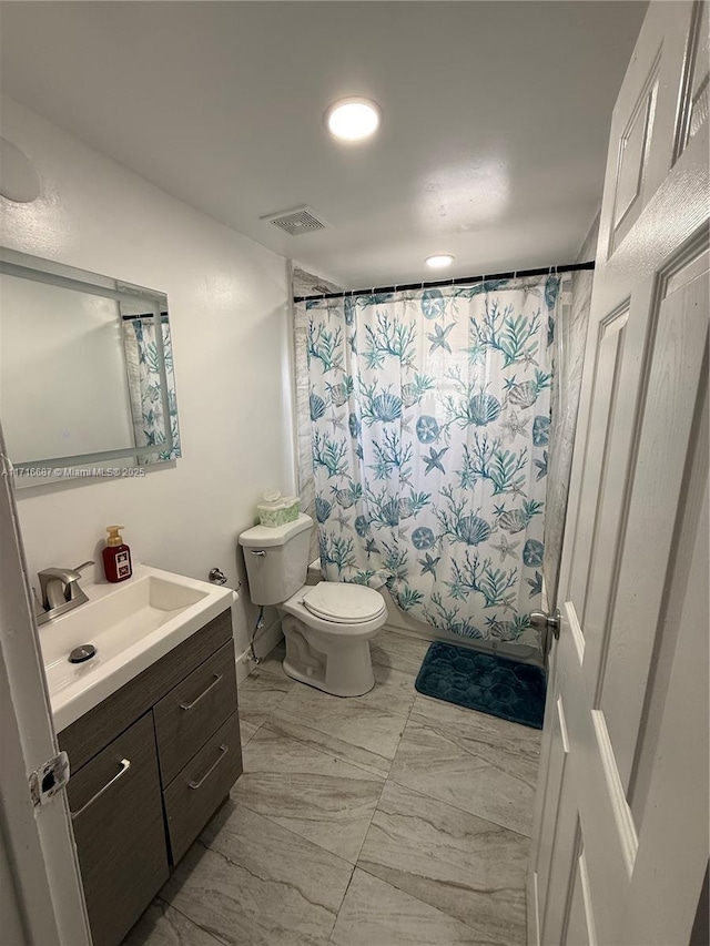 bathroom featuring vanity and toilet