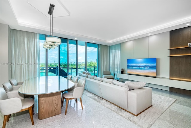 living room featuring a wall of windows and a chandelier