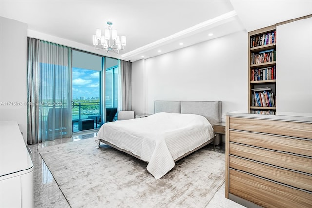 bedroom with expansive windows, access to exterior, and a chandelier