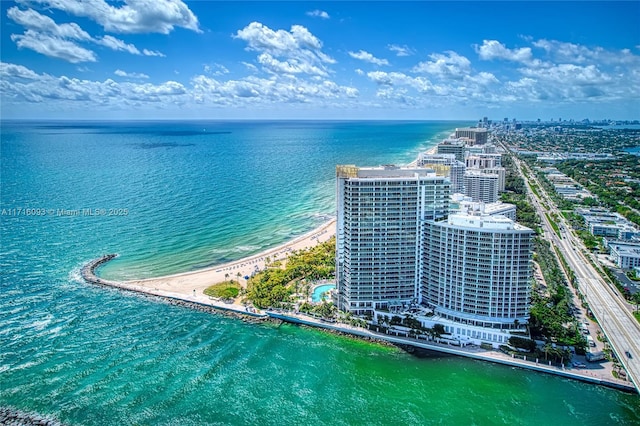 birds eye view of property with a water view and a view of the beach