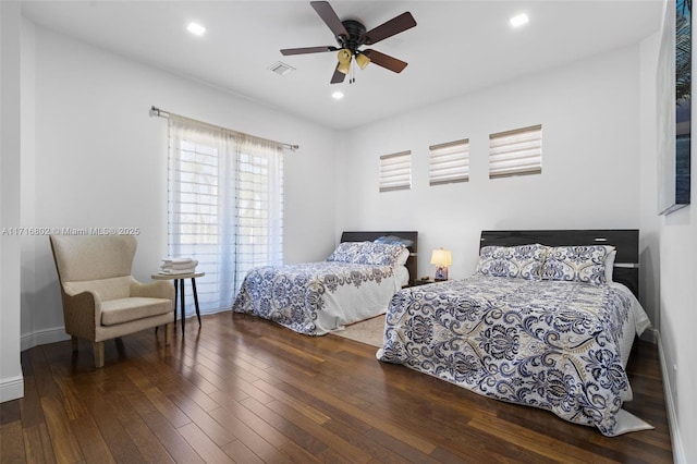 bedroom with ceiling fan and dark hardwood / wood-style flooring