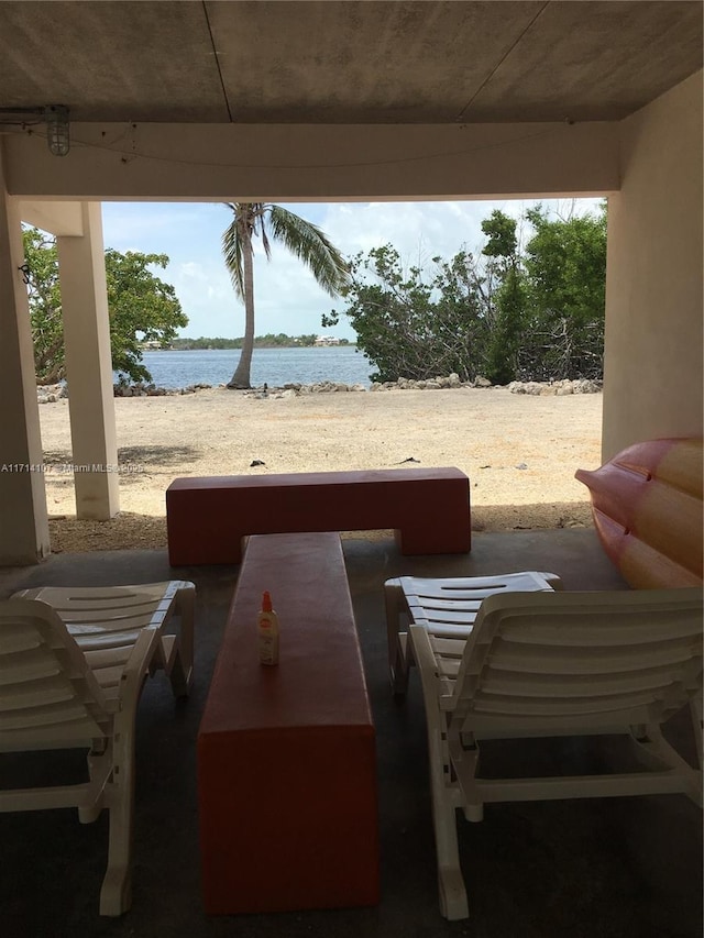 view of patio with a water view