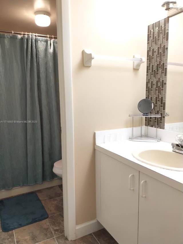 bathroom with vanity, a shower with shower curtain, and toilet