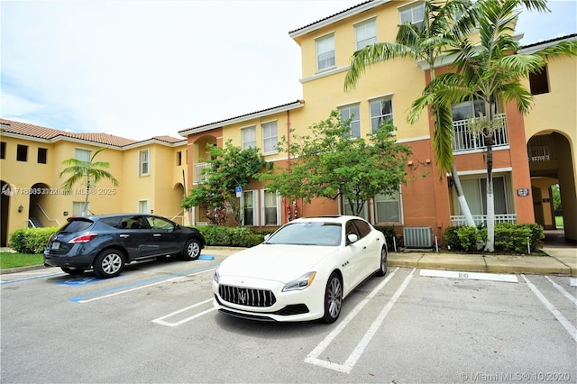 view of building exterior featuring uncovered parking