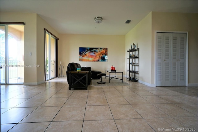 sitting room with light tile patterned floors, visible vents, and baseboards