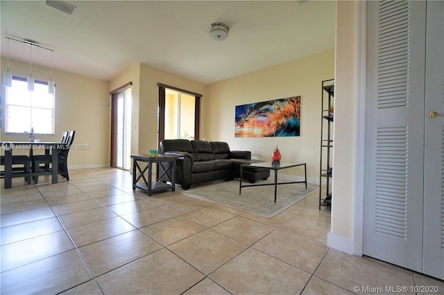 living room with light tile patterned flooring and baseboards