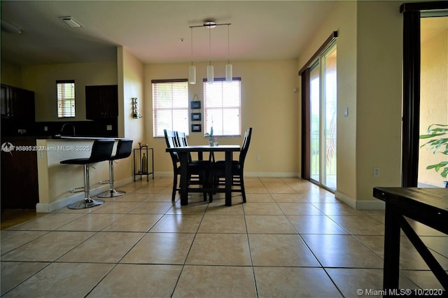 dining room with light tile patterned floors, visible vents, and baseboards