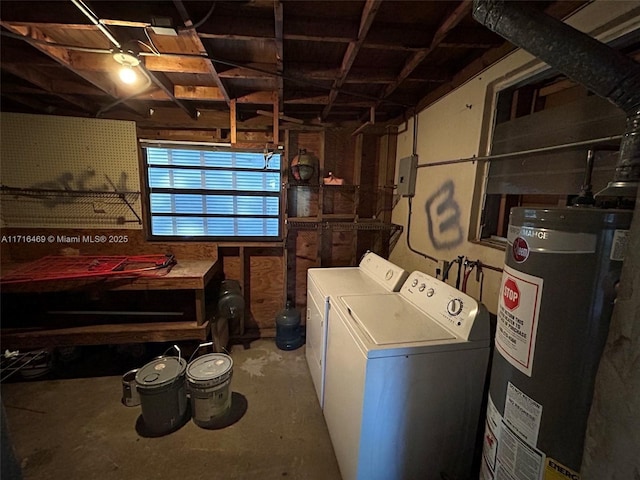 washroom featuring laundry area, a workshop area, gas water heater, and washing machine and clothes dryer