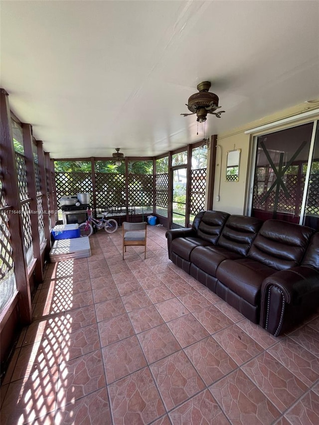 living room featuring a sunroom and ceiling fan