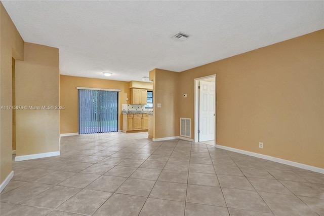 spare room with light tile patterned flooring