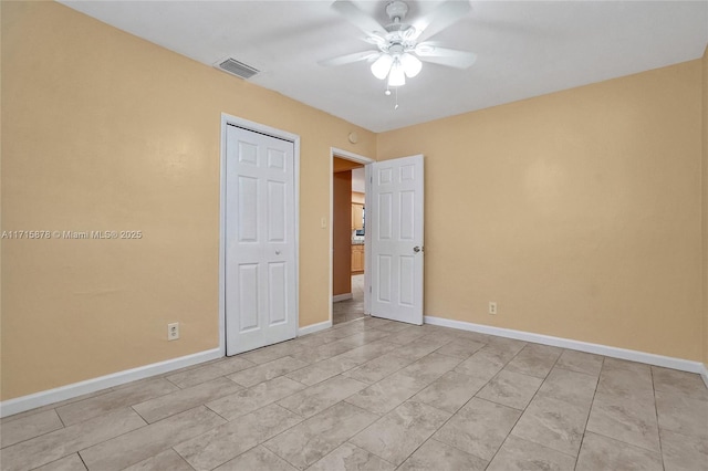 unfurnished bedroom featuring ceiling fan and a closet