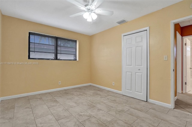 unfurnished bedroom with ceiling fan, a closet, and light tile patterned floors