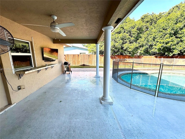 view of swimming pool with ceiling fan and a patio area