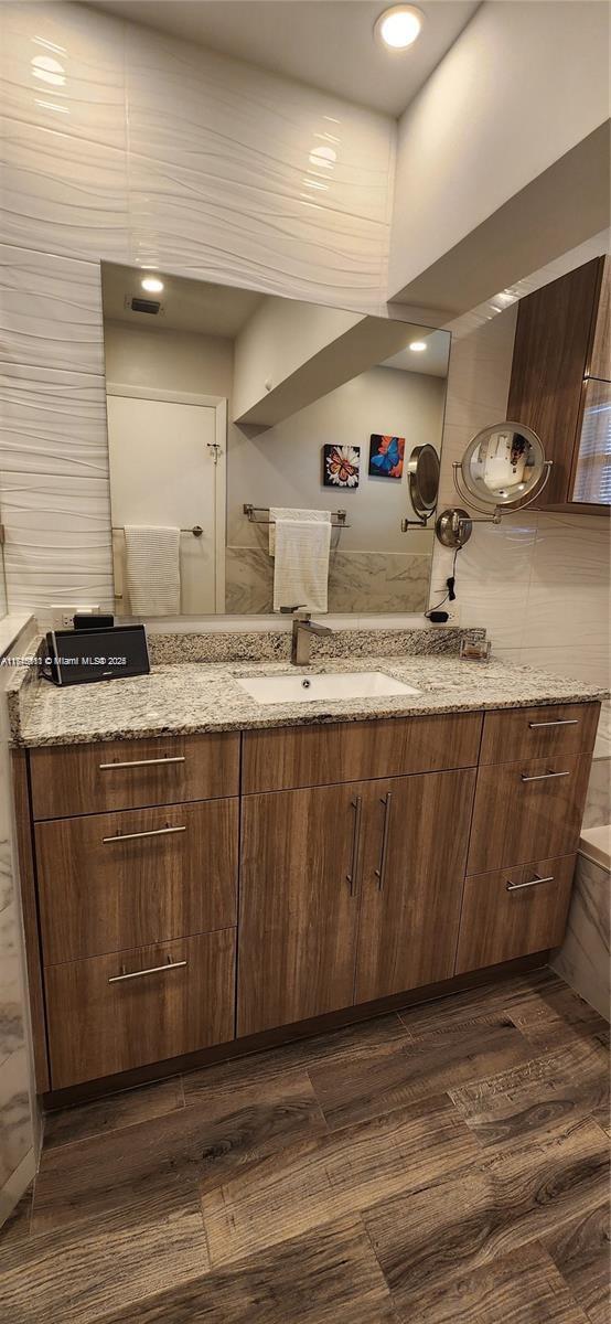 bathroom with hardwood / wood-style flooring and vanity