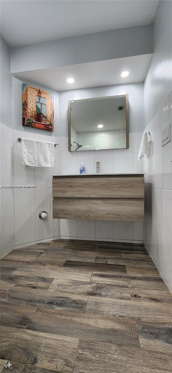 bathroom featuring vanity and hardwood / wood-style flooring