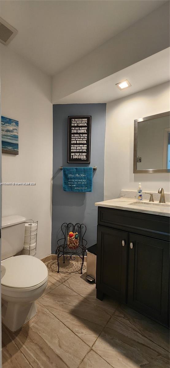 bathroom featuring vanity and toilet