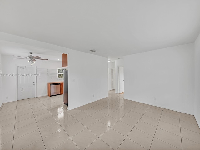 spare room featuring ceiling fan and light tile patterned floors