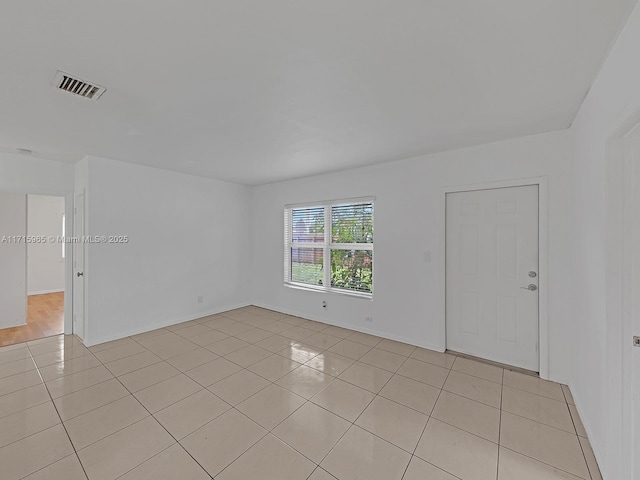 empty room with light tile patterned floors