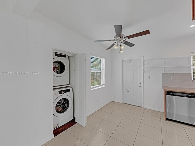 clothes washing area featuring light tile patterned flooring, ceiling fan, and stacked washer / dryer