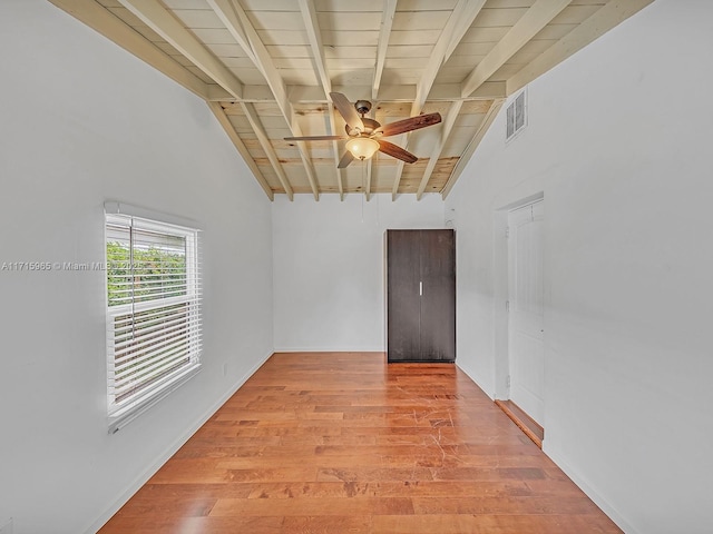 unfurnished room featuring lofted ceiling with beams, ceiling fan, wooden ceiling, and light wood-type flooring