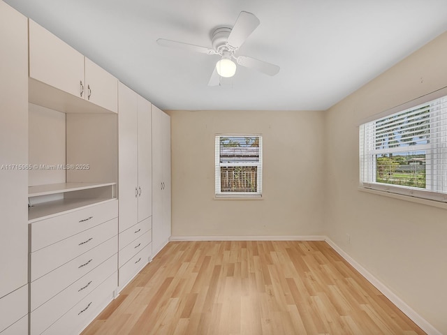 unfurnished bedroom with ceiling fan and light hardwood / wood-style flooring