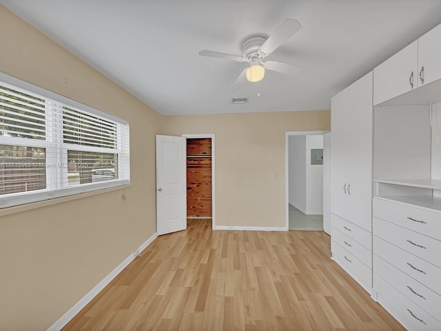 unfurnished bedroom with light hardwood / wood-style floors, ceiling fan, and a closet