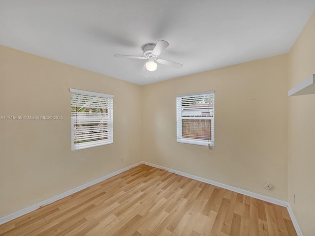 unfurnished room featuring a wealth of natural light, ceiling fan, and light wood-type flooring