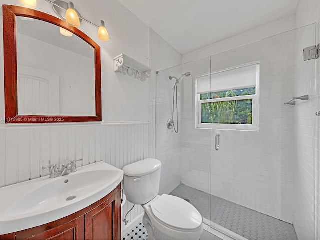 bathroom featuring walk in shower, vanity, and toilet