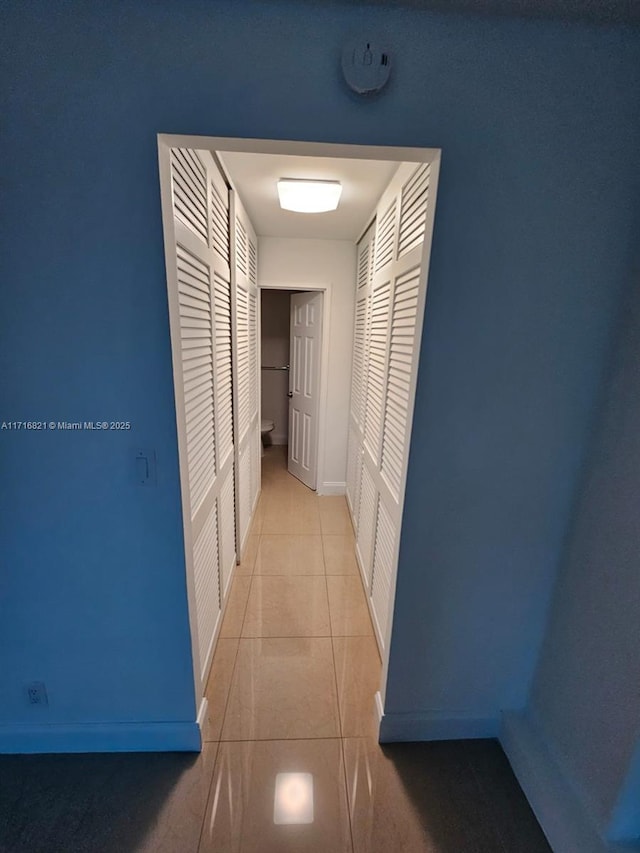 hallway featuring light tile patterned floors