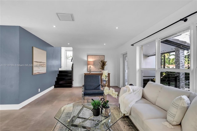 living room with a fireplace and concrete flooring