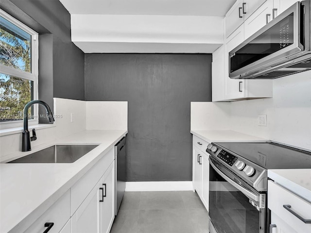 kitchen featuring white cabinets, stainless steel appliances, and sink