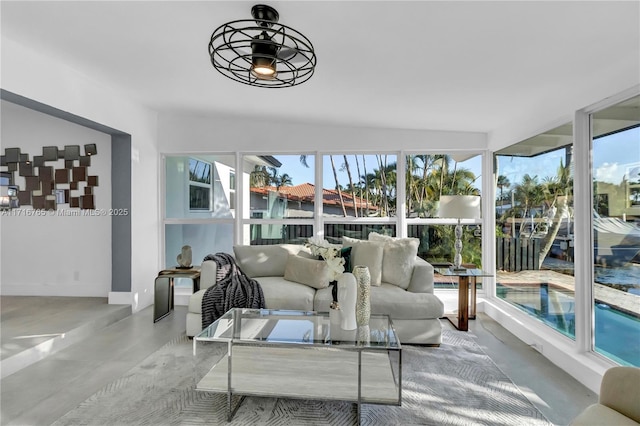 sunroom / solarium featuring a wealth of natural light and ceiling fan