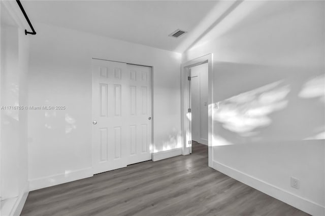 unfurnished room featuring dark wood-type flooring