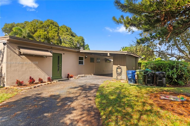 rear view of house featuring a carport