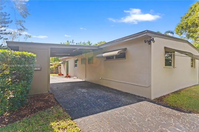 view of side of property featuring a carport