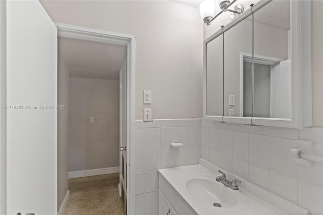 bathroom featuring tile walls and vanity