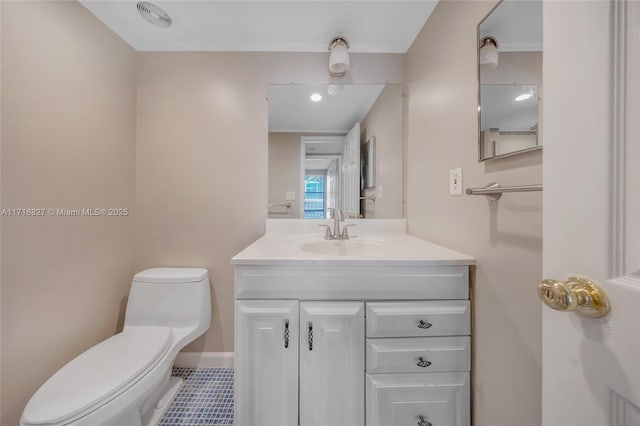 bathroom featuring vanity and toilet