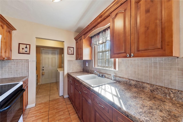 kitchen featuring decorative backsplash, light tile patterned floors, electric range, and sink