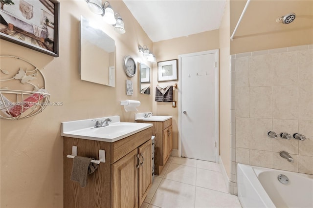 bathroom with tile patterned floors, vanity, and tiled shower / bath