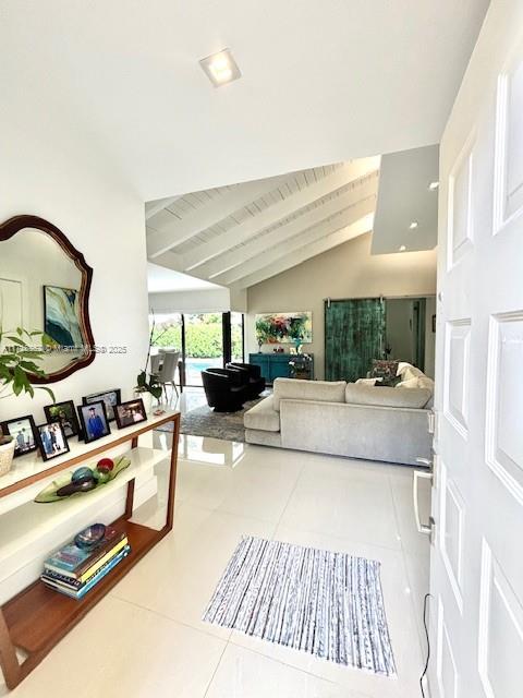 interior space featuring lofted ceiling with beams, tile patterned flooring, and wood ceiling