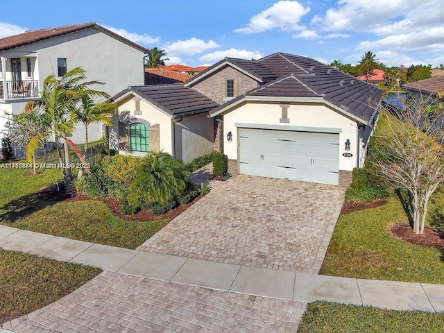 view of front of house featuring a garage and a front lawn